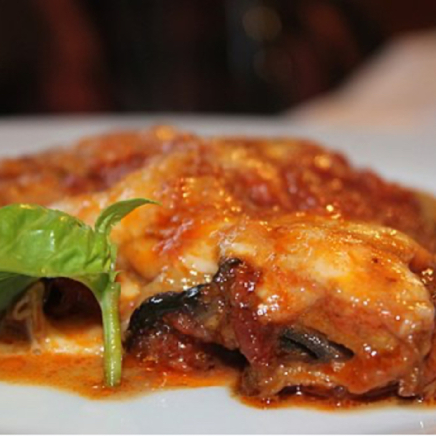 Parmigiana is an Italian dish made with fried, sliced eggplant layered with cheese episode artwork