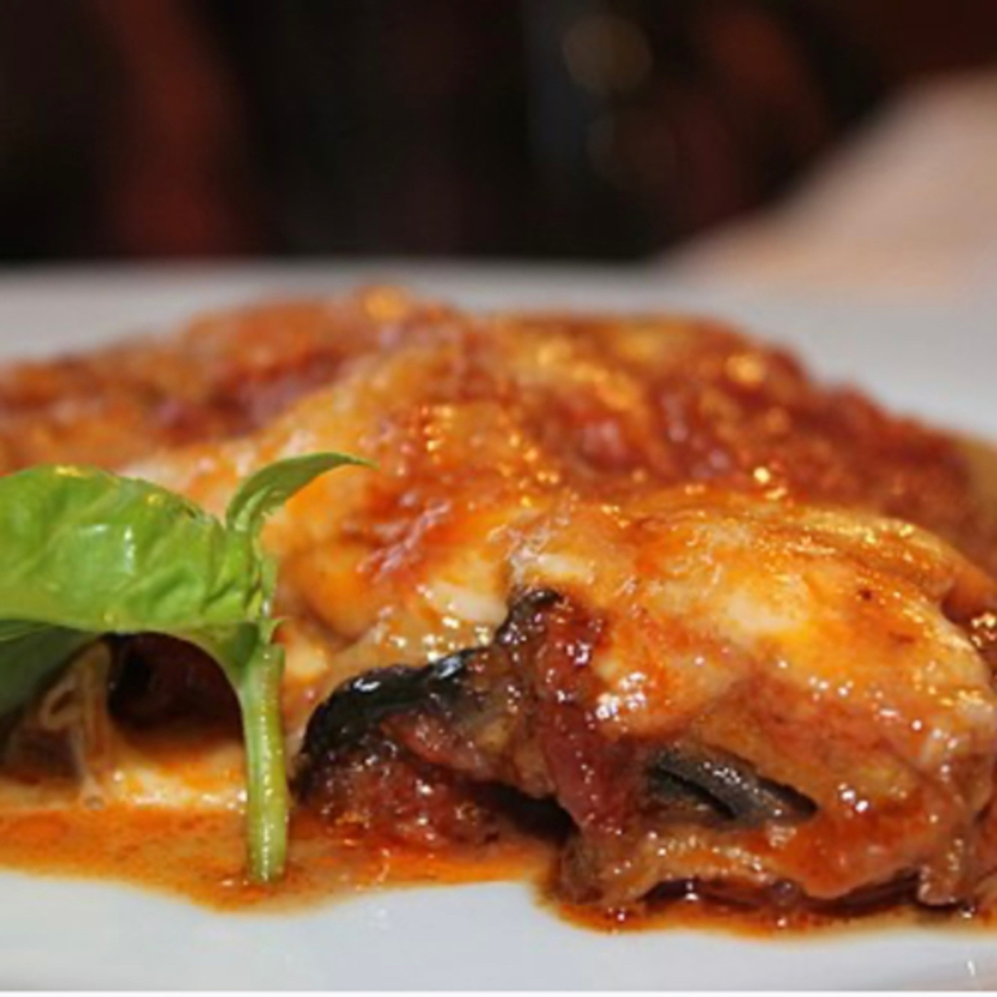 Parmigiana is an Italian dish made with fried, sliced eggplant layered with cheese episode artwork